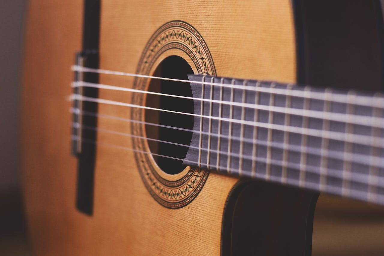 Detailed close-up view of a classical acoustic guitar showcasing its strings and craftsmanship.